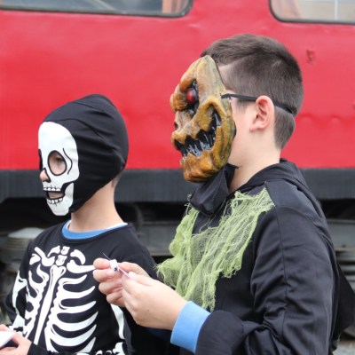 a group of people standing in front of a bus