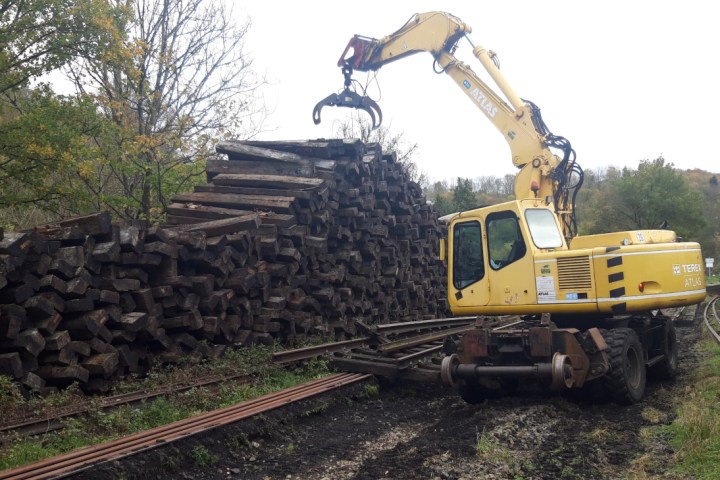 a train traveling down train tracks near a forest