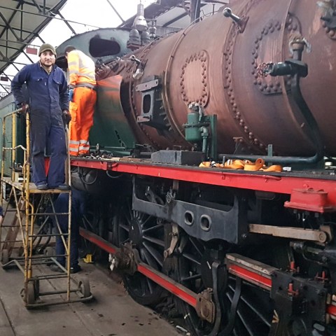 a man standing next to a train