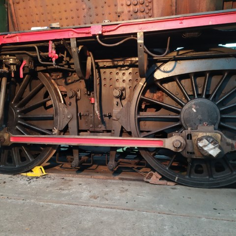 a train is parked on the side of a building