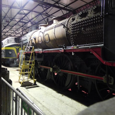 a train is parked on the side of a building