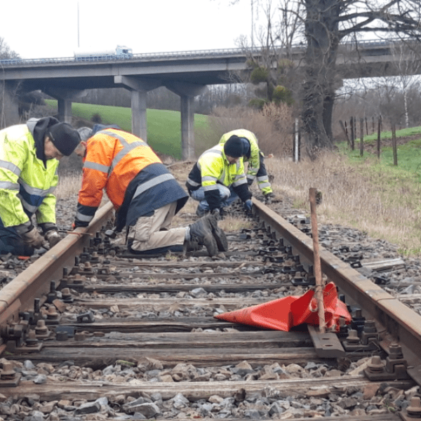 a man riding a bike down a dirt road