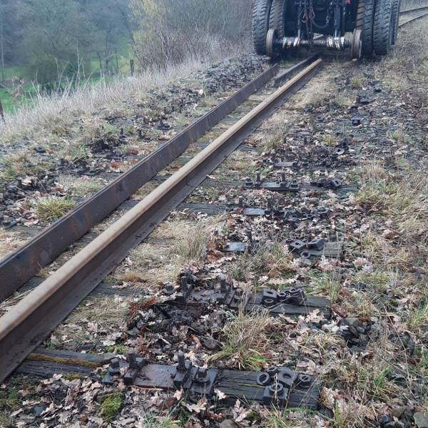 a train traveling down a dirt road