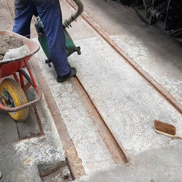 a person sitting on a sidewalk