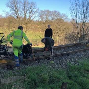 a man riding a bike down a dirt road