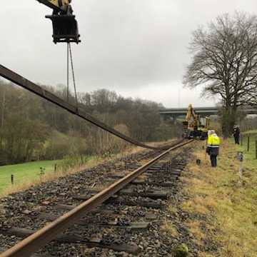 a train on a train track with trees in the background