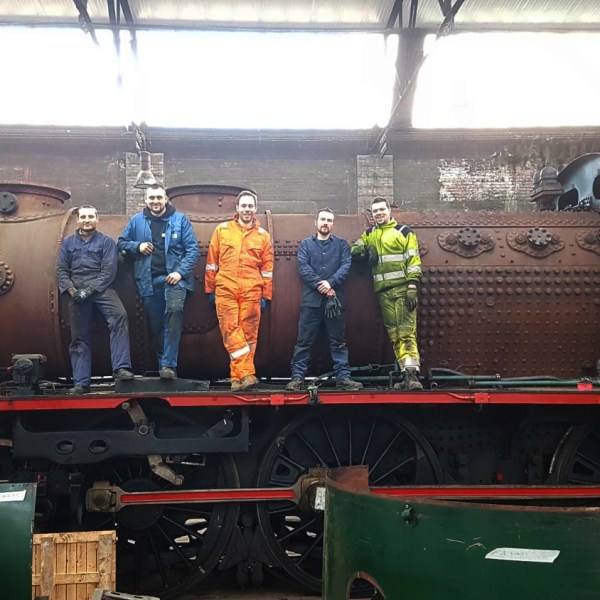 a group of people riding on the back of a truck