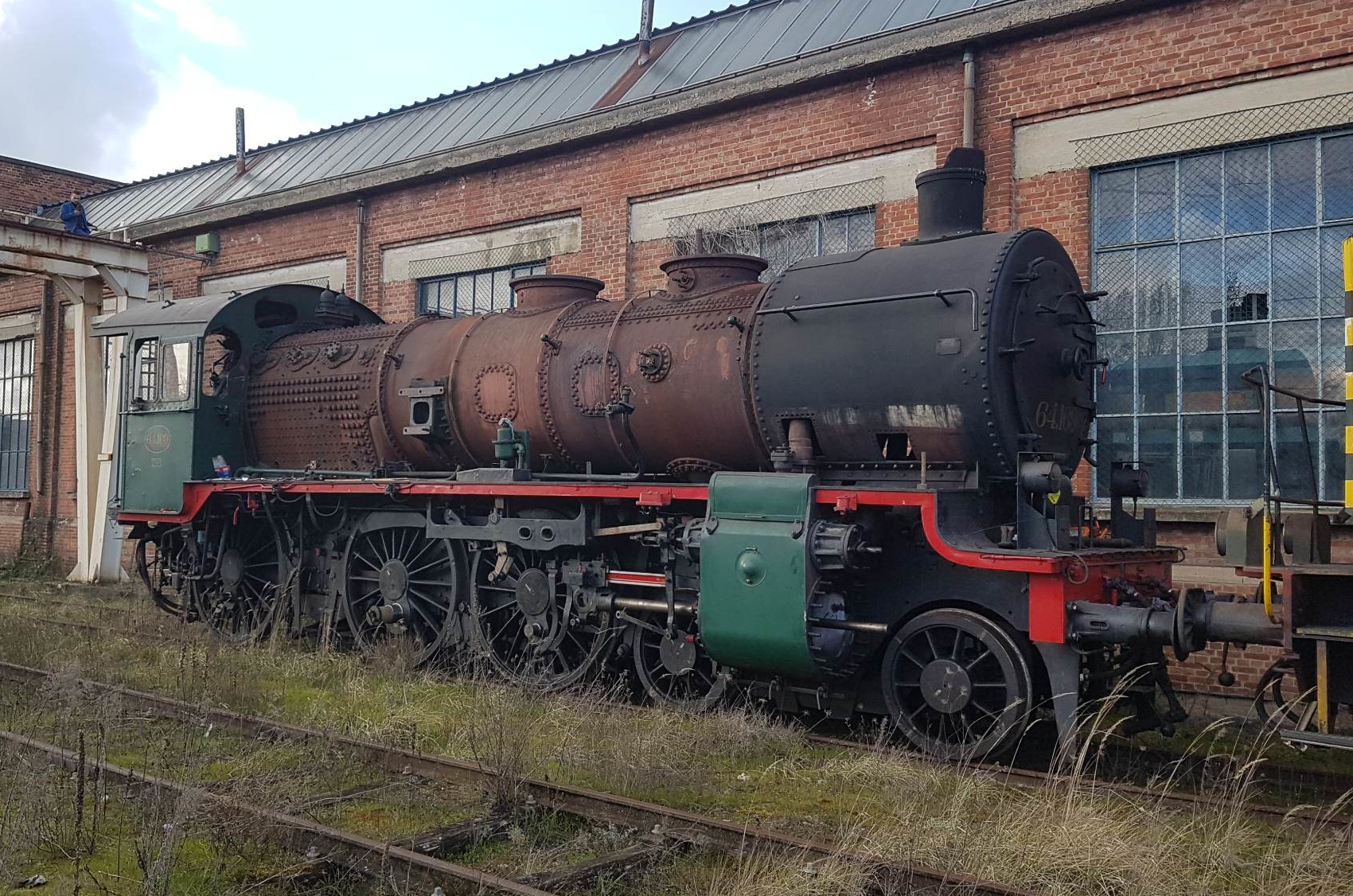 a train is parked on the side of a building