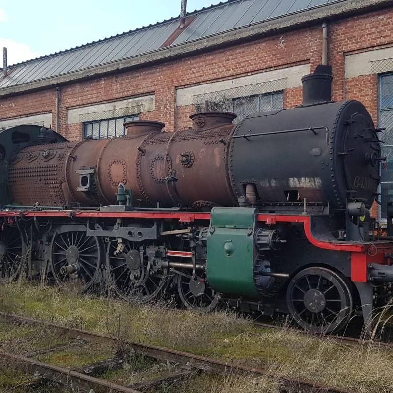 a train is parked on the side of a building