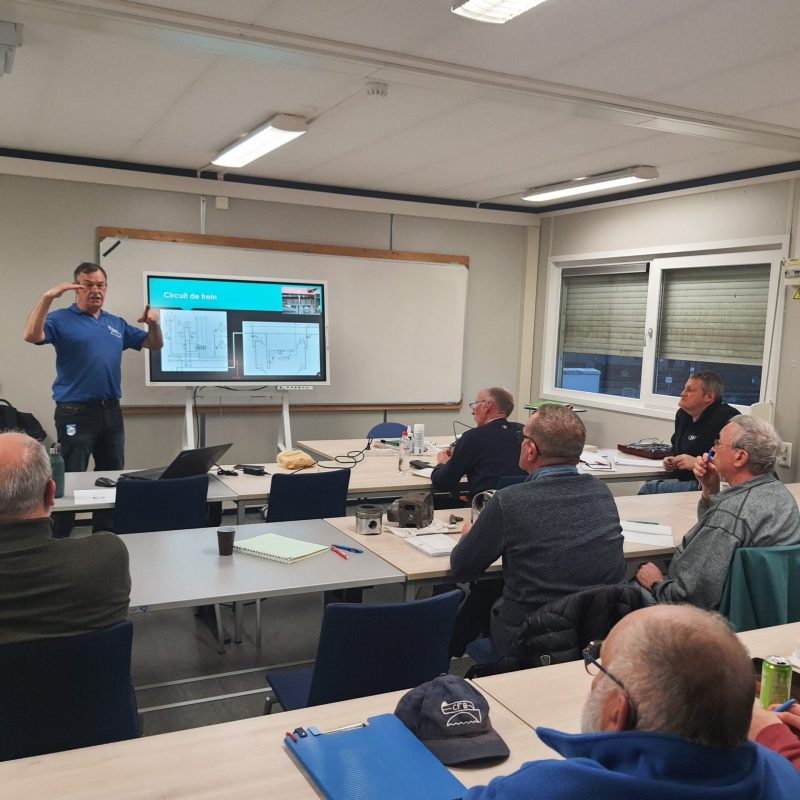 a group of people sitting at a table in a room