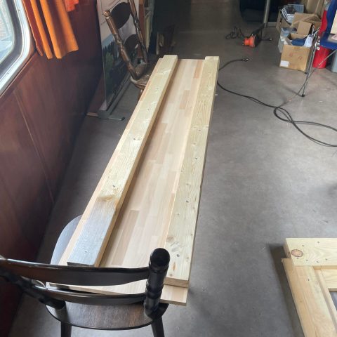 a laptop computer sitting on top of a wooden table