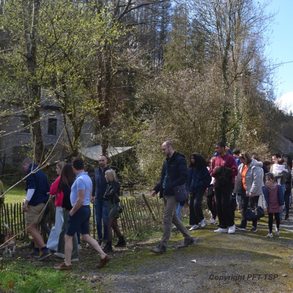 a group of people standing on a train track with trees in the background