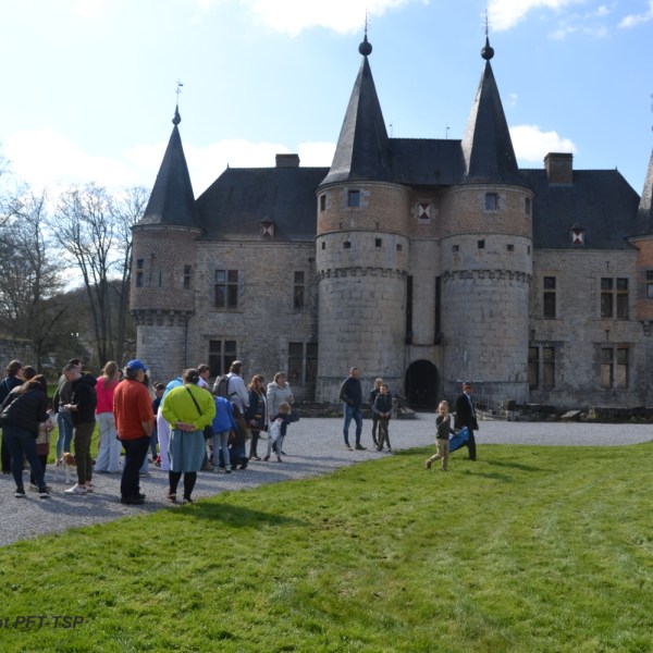 a group of people standing in front of a castle
