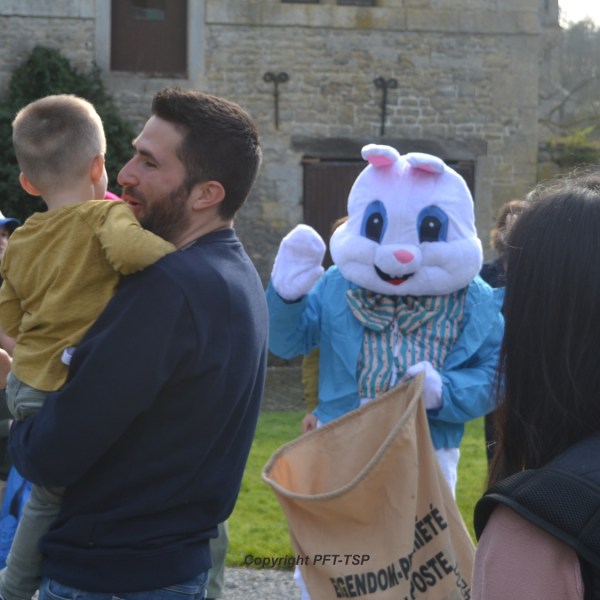 a group of people that are standing in the grass