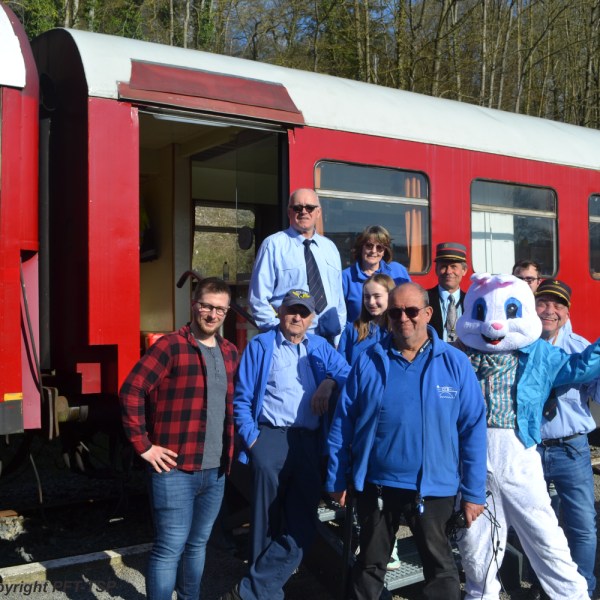 a group of people standing in front of a train