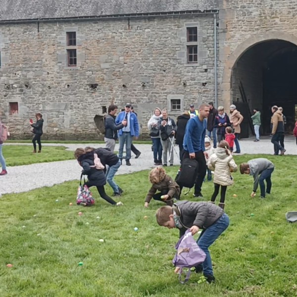 a group of people walking in front of a brick building
