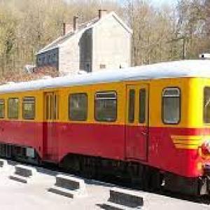 a passenger train that is traveling down the street