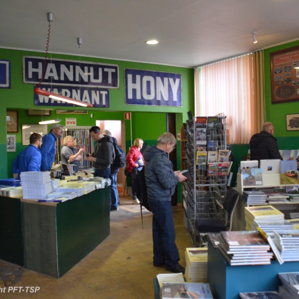 a group of people standing in front of a store