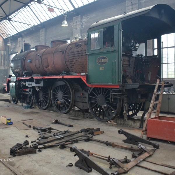 a train is parked on the side of a building