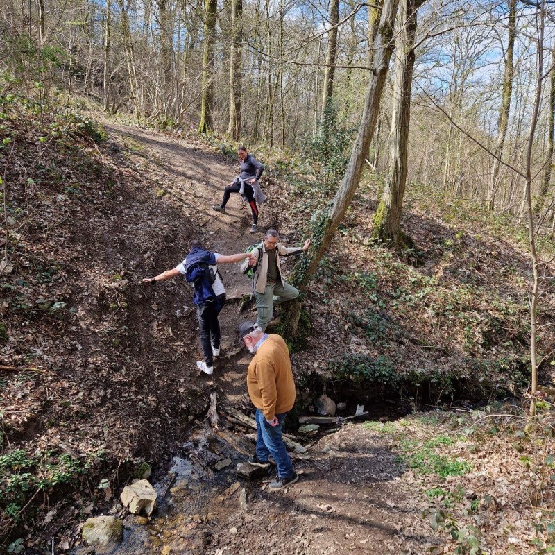 a man riding a bike down a dirt road