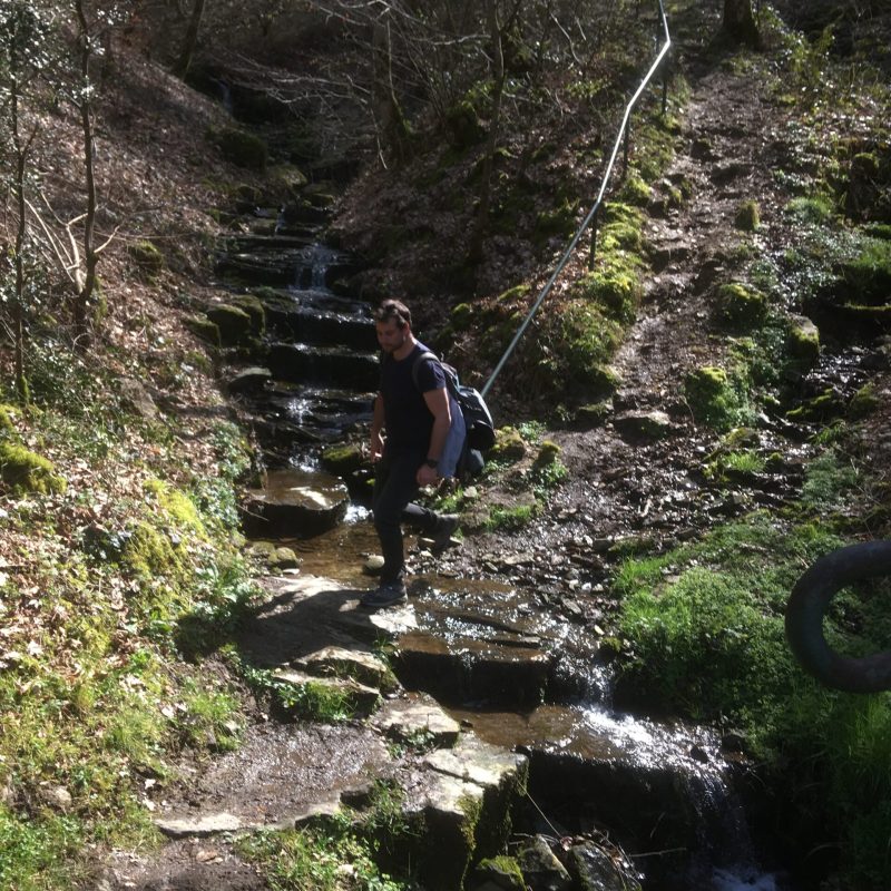 a person standing next to a waterfall