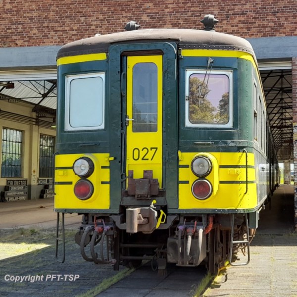 a train is parked on the side of a building