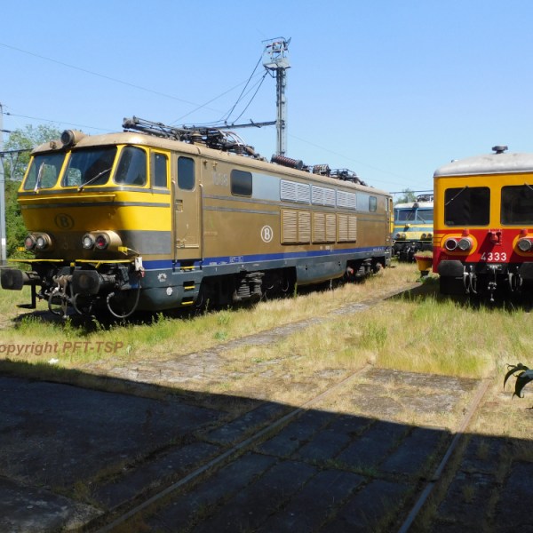 a train is parked on the side of a school bus