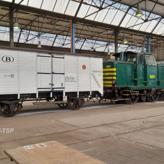 a train is parked on the side of a building