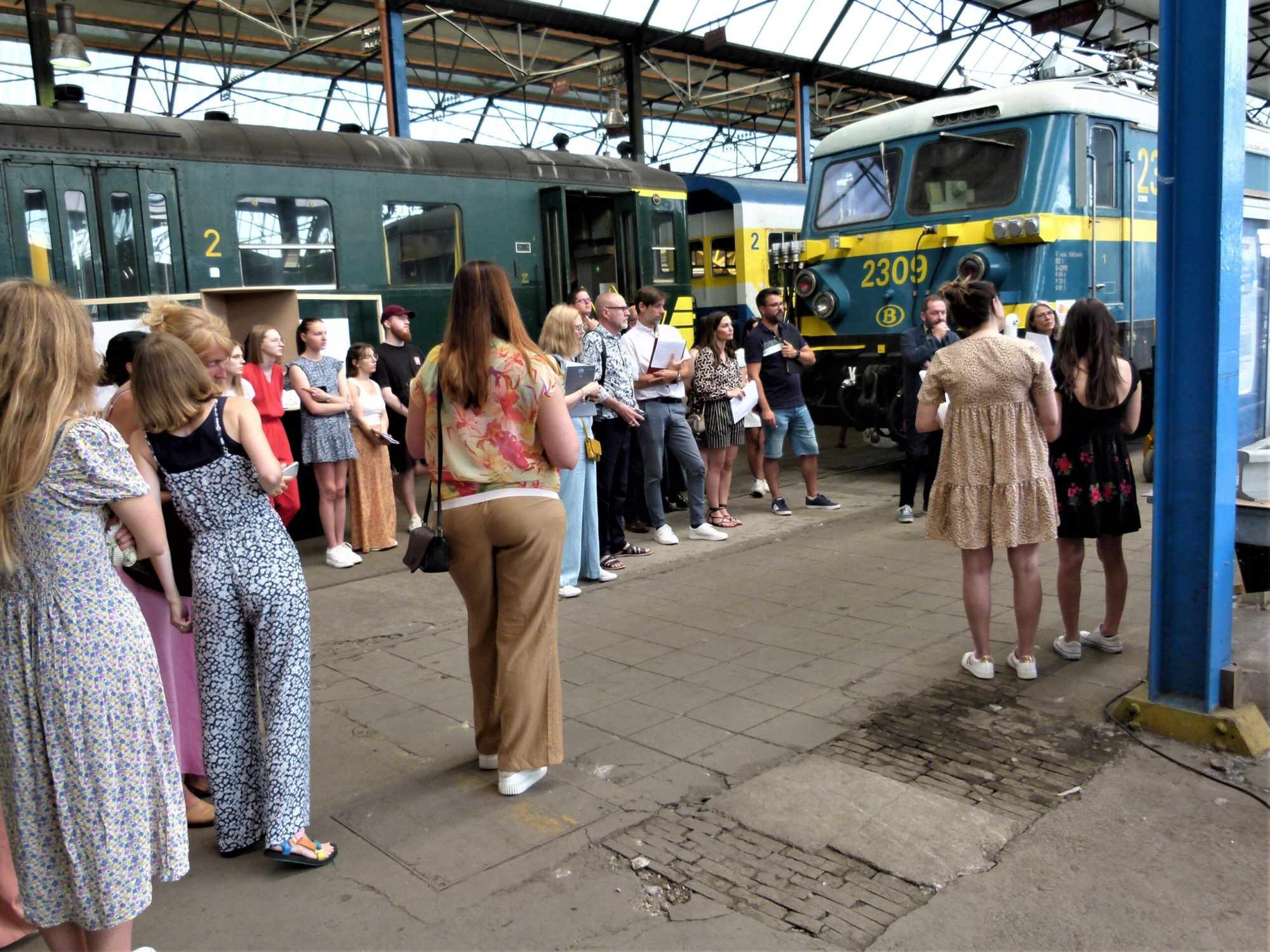 a group of people standing around a bus