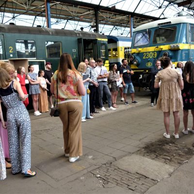 a group of people standing around a bus