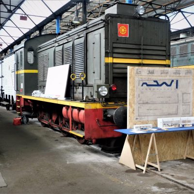 a train is parked on the side of a building
