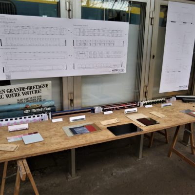 a desk with a laptop computer sitting on top of a wooden table