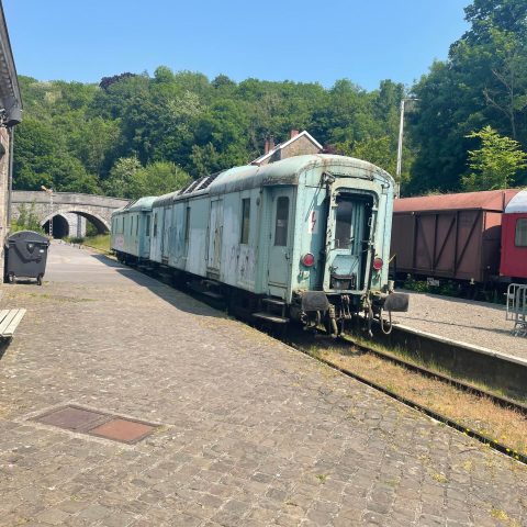 a train is parked on the side of the road