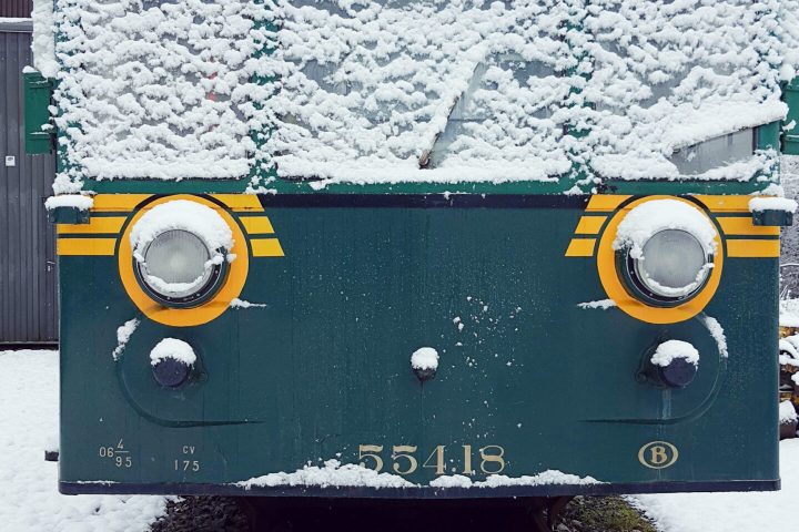 a train cake sitting on top of a snow covered field