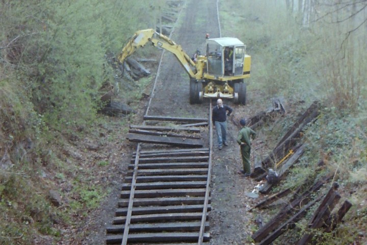 a train traveling down a dirt road