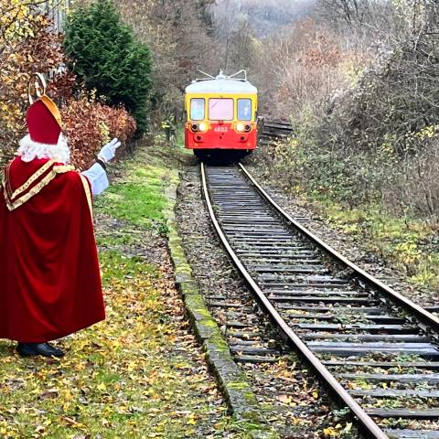 a train on a train track with trees in the background