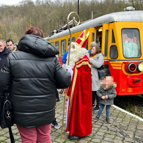 a group of people standing around a bus