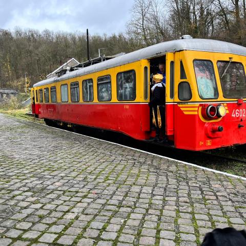 a passenger bus that is sitting on a train track