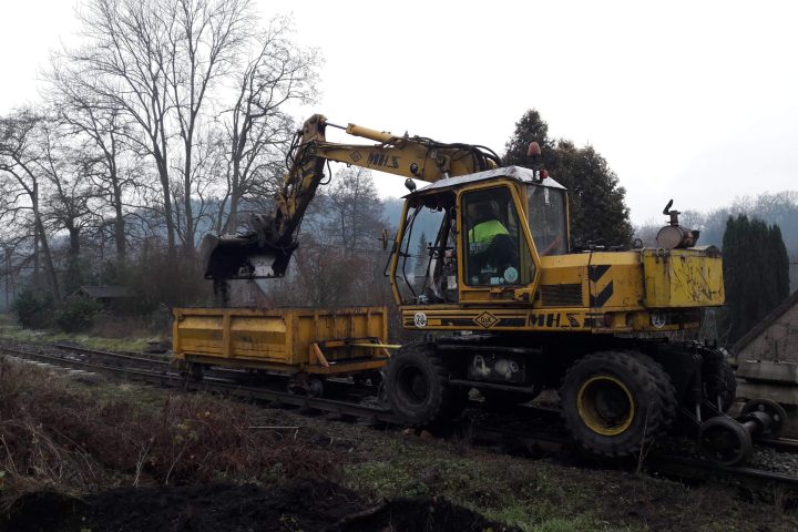 a truck is parked on the side of a dirt field
